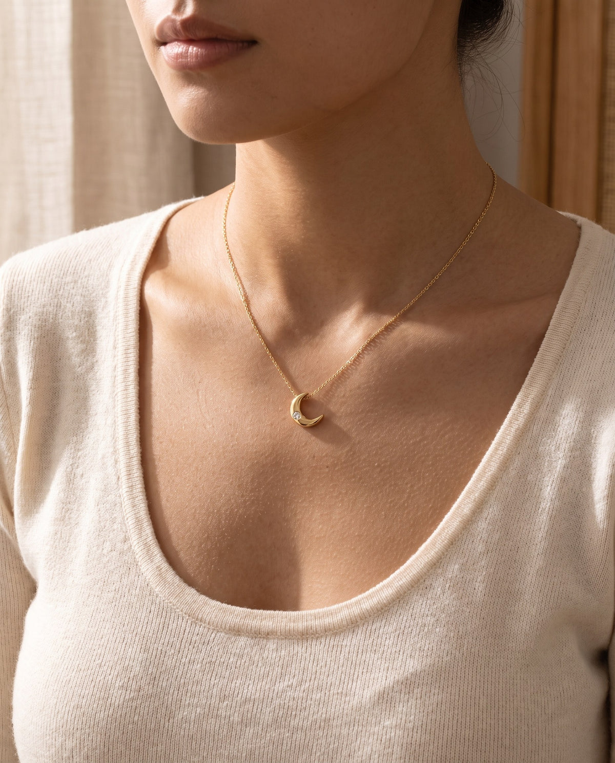 Woman wearing the Crescent Moon Pendant Necklace at the collarbone