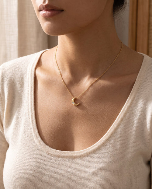 Woman wearing the Crescent Moon Pendant Necklace at the collarbone