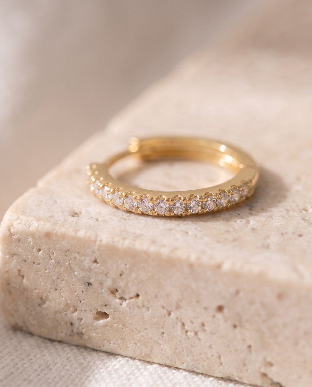Close-up of the row of small cubic zirconia stones on the Huggie Hoop Earrings