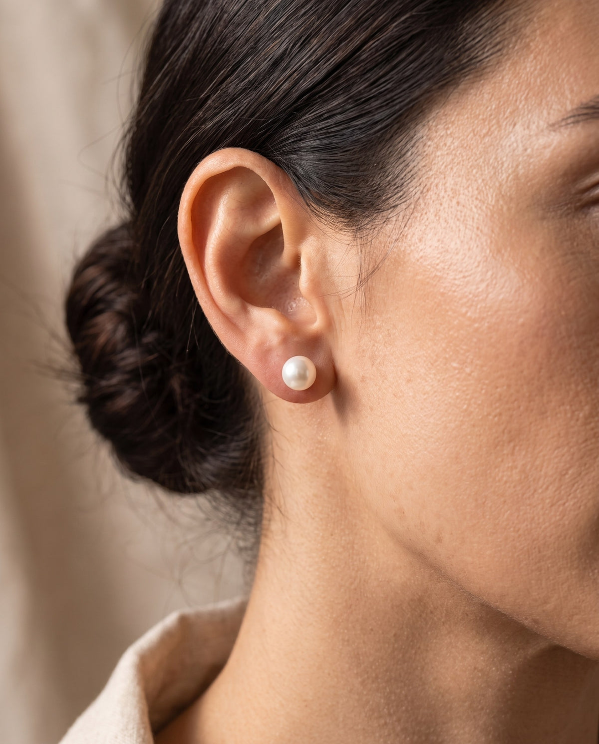 Woman wearing a white Glass Pearl Stud Earring with her hair pulled back