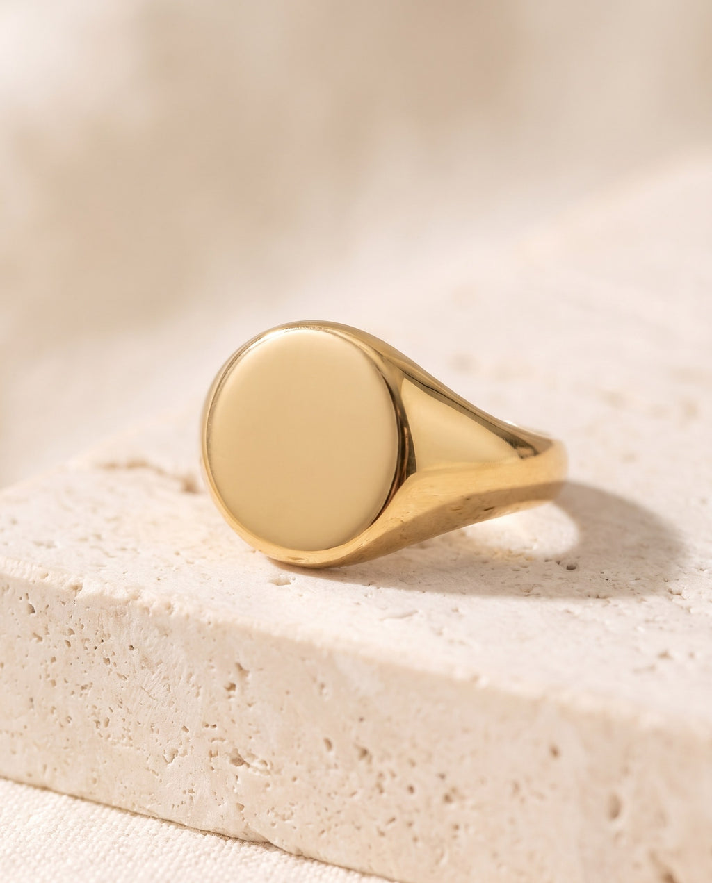 Close-up of the smooth polished oval face of the gold-plated Signet Ring