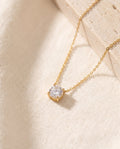 Solitaire Pendant Necklace with one round cubic zirconia in a four-claw setting on ivory linen